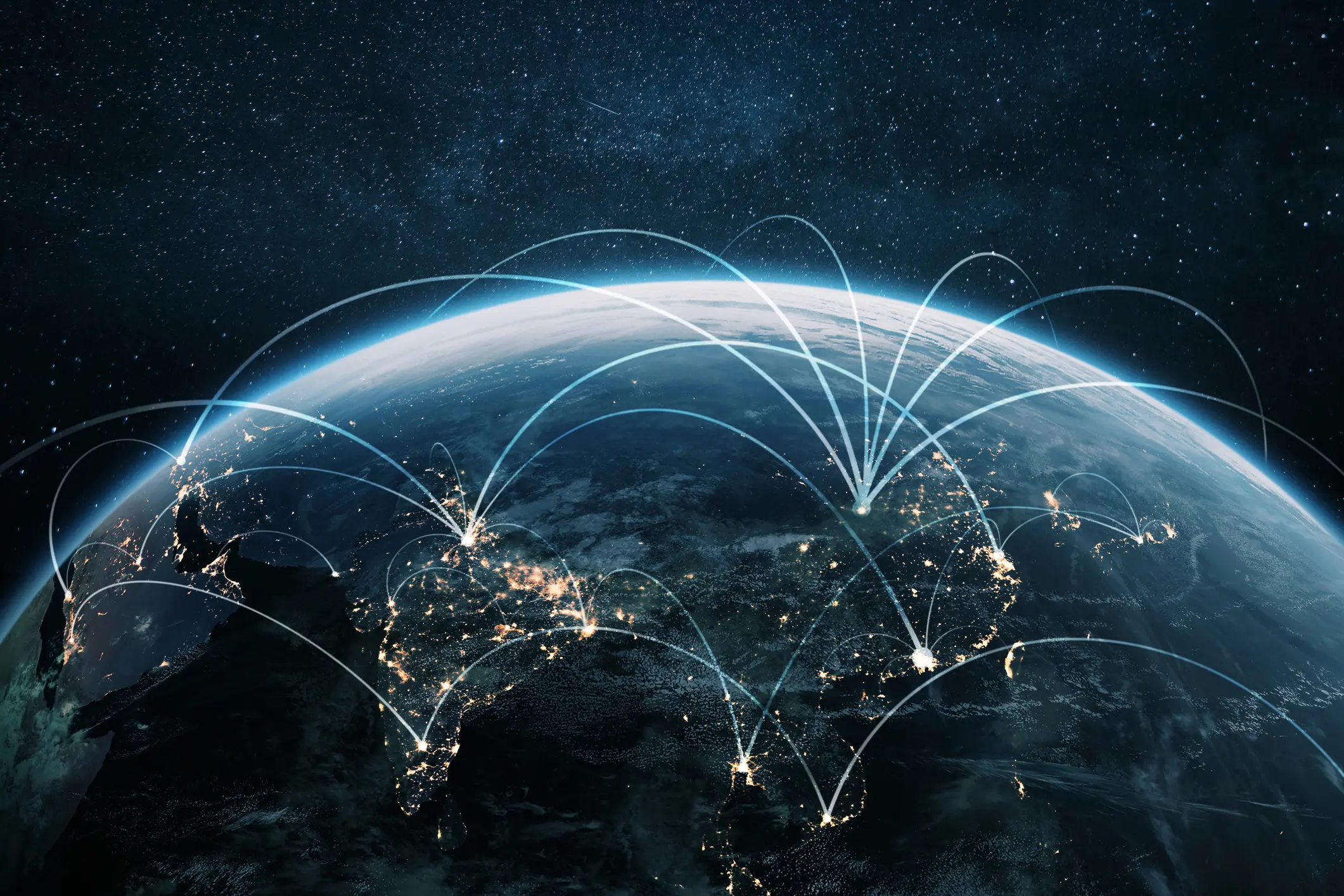 Global network connections illustrated by glowing lines over a nighttime Earth.